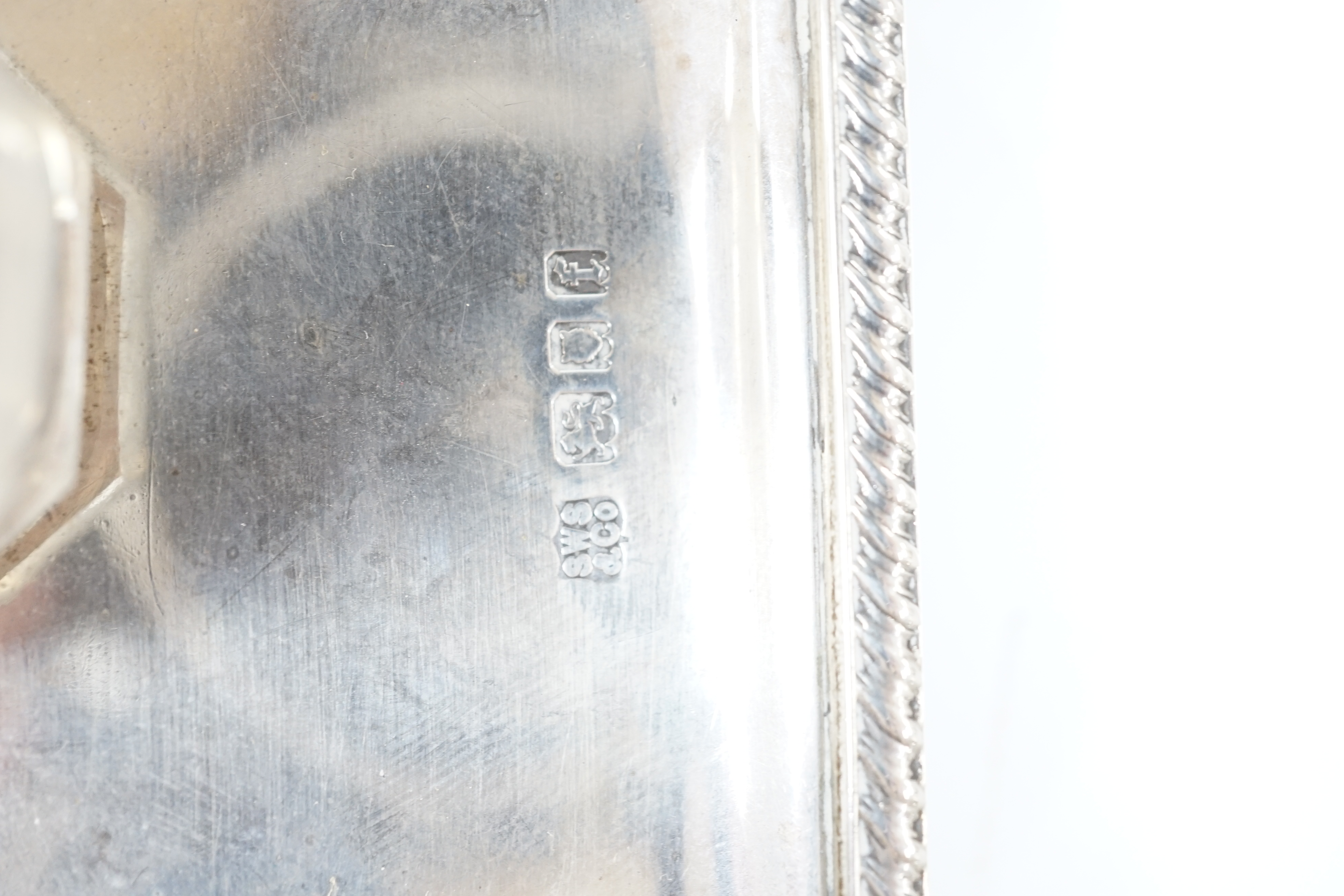 A George V silver inkstand with two silver mounted glass wells, with engraved inscription, S.W. Smith & Co, London, 1921, 21.5cm, 9.6oz. Condition- poor to fair